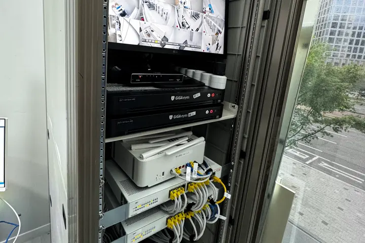 Communications cabinet with equipment and cabling routed on each floor