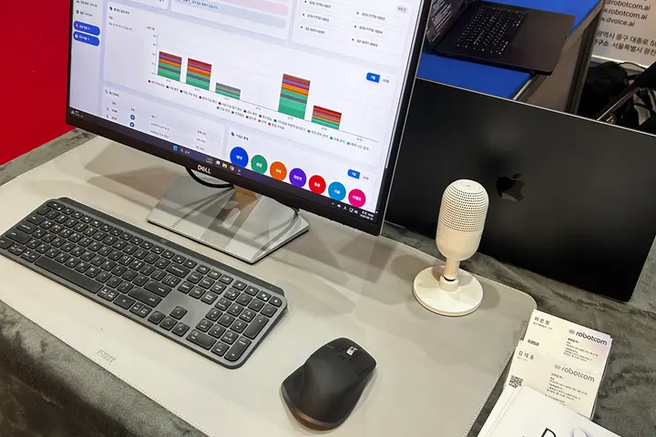 A screen running D voice next to printed product material